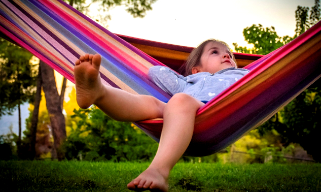 Stop Waiting for a Better Tomorrow child laying back in a hammock